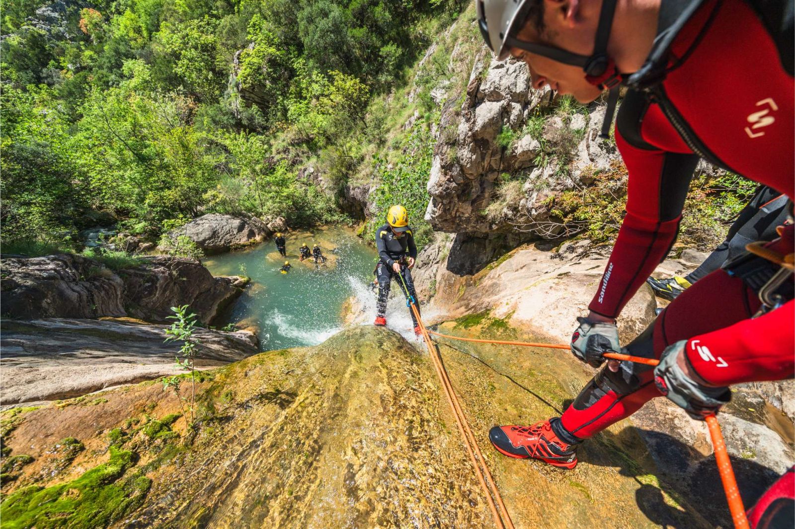 Guest abseiling down a waterfall in Drenostica Canyon